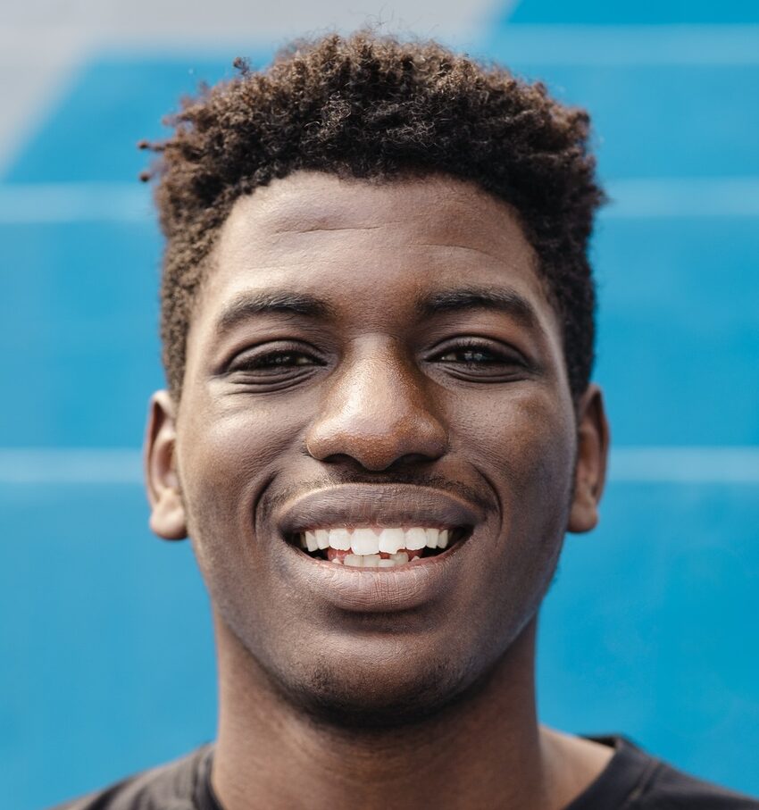 Happy young African teenager smiling in front of camera